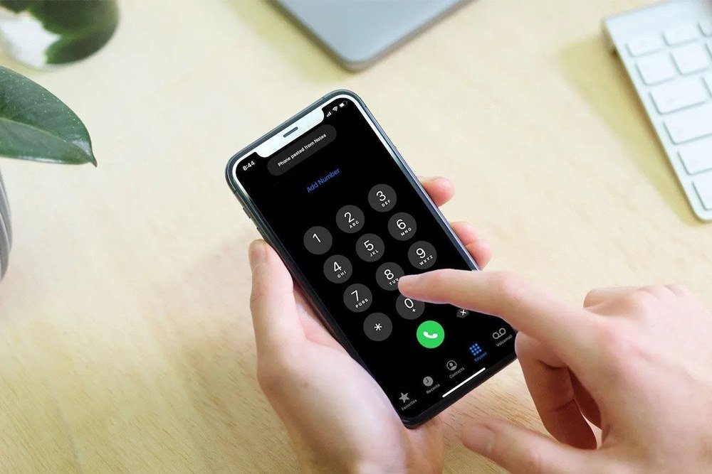 Rear view of a man checking his phone